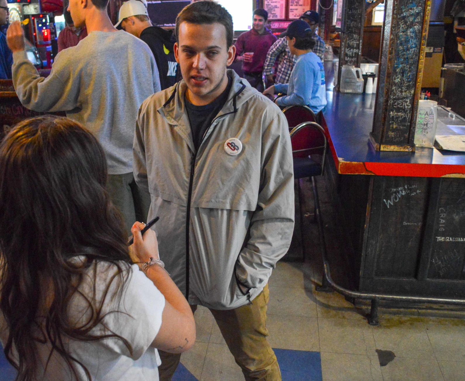 A U.D.K. reporter interviews Zach Thomason inside The Wheel as Crimson and Blue members await election results.